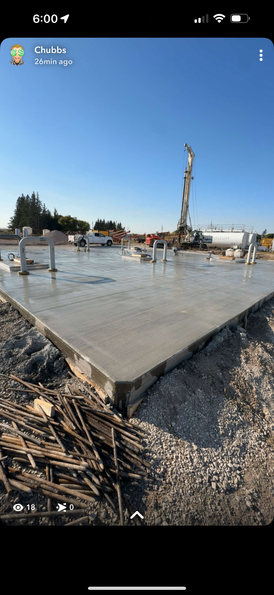Finished concrete fuel pad with bollards and dispenser cutouts at a Manitoba cardlock site